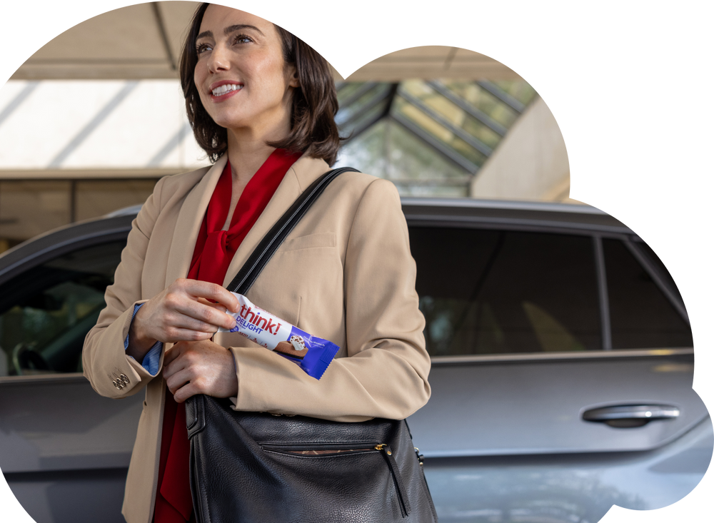 Woman with think protein bar on the go
