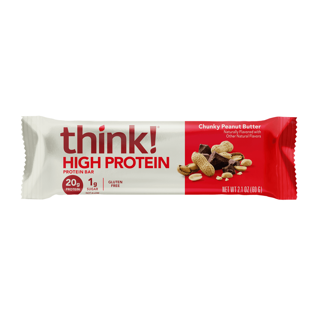 Packaging of a "think! High Protein" bar, chunky peanut butter flavor. It shows peanuts and chocolate, highlighting 20g protein, 1g sugar, and gluten-free.