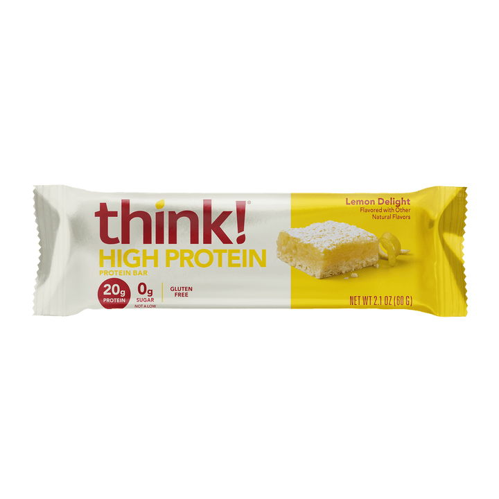 A protein bar wrapper with the brand "think!" in bold red letters. It reads "High Protein" and "Lemon Delight" flavor on a yellow background, highlighting 20g protein and 0g sugar.
