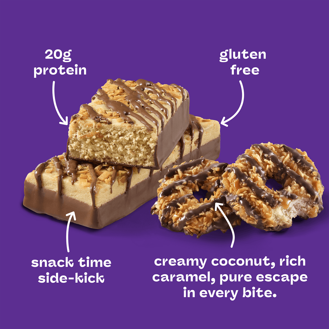 Protein bars and cookies on a purple background. The bar, labeled “20g protein,” is topped with chocolate and caramel. Nearby are gluten-free cookies drizzled with chocolate, described as creamy coconut and rich caramel for a snack escape.
